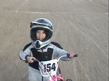 A small girl on a bmx bike at a race